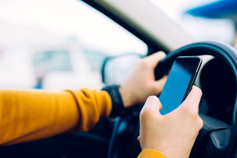 person texting while driving in Texas