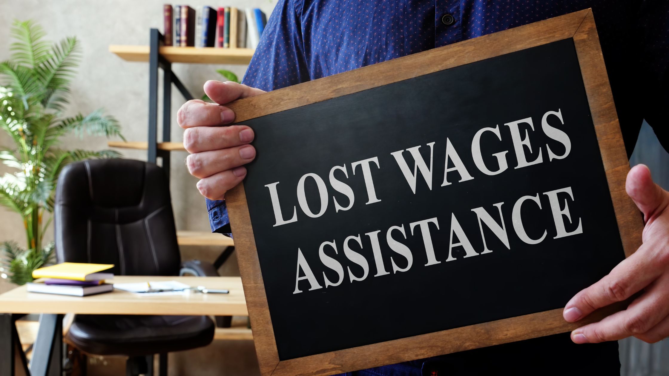A person holds a chalkboard sign stating 'LOST WAGES ASSISTANCE,' indicating support for recovering lost income after a car accident in Texas.